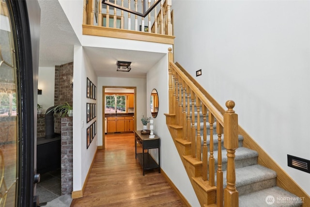 15513 NE Beebe Rd, Battle Ground, WA 98604 - staircase featuring wood finished floors, a wood stove, and baseboards