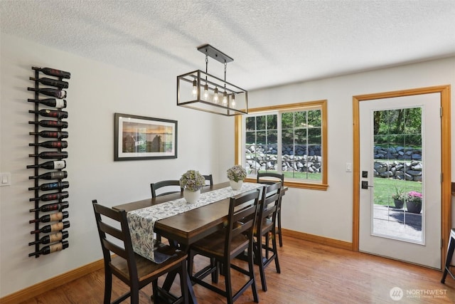 15513 NE Beebe Rd, Battle Ground, WA 98604 - dining area featuring a textured ceiling, light wood finished floors, and baseboards