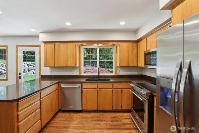 15513 NE Beebe Rd, Battle Ground, WA 98604 - kitchen with stainless steel appliances, a sink, plenty of natural light, a peninsula, and recessed lighting