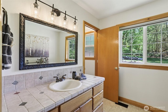 15513 NE Beebe Rd, Battle Ground, WA 98604 - bathroom with tasteful backsplash, baseboards, vanity, and tile patterned floors