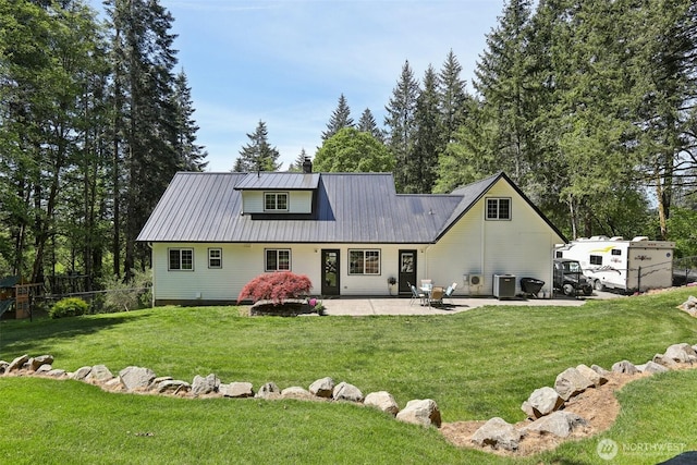 15513 NE Beebe Rd, Battle Ground, WA 98604 - rear view of property featuring a patio, cooling unit, a chimney, and metal roof