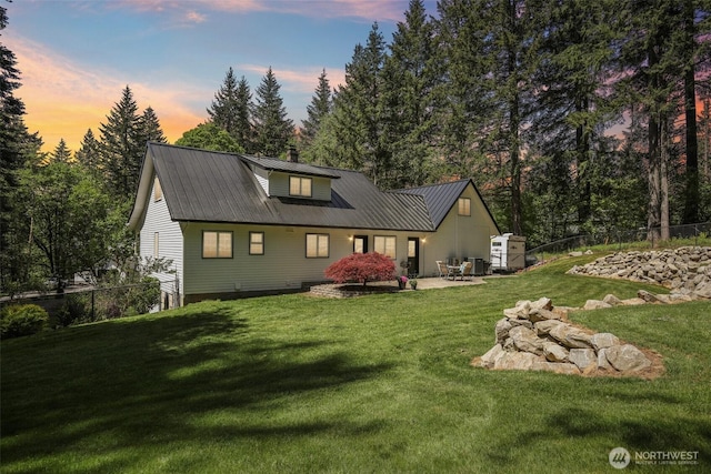 15513 NE Beebe Rd, Battle Ground, WA 98604 - rear view of house with metal roof, a patio area, and a chimney