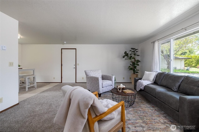 tiled living area featuring a textured ceiling and baseboards