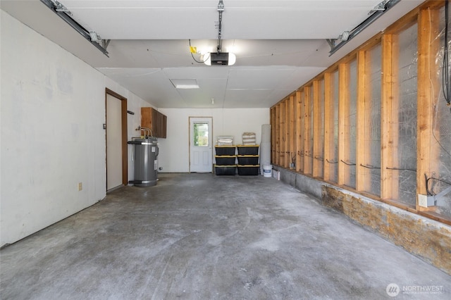 garage with a garage door opener and electric water heater
