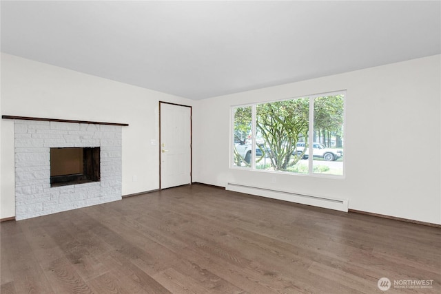 5015 15th Ave SE, Lacey, WA 98503 - unfurnished living room with a baseboard radiator, wood finished floors, a fireplace, and baseboards