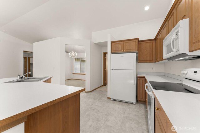 13008 65th Avenue Ct SW, Lakewood, WA 98499 - kitchen featuring white appliances, a chandelier, a sink, light countertops, and brown cabinets