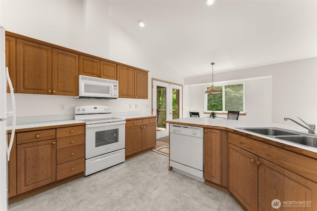 13008 65th Avenue Ct SW, Lakewood, WA 98499 - kitchen featuring white appliances, brown cabinets, lofted ceiling, a sink, and light countertops