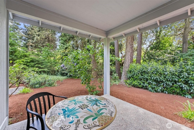13008 65th Avenue Ct SW, Lakewood, WA 98499 - view of patio / terrace featuring outdoor dining area and view of wooded area