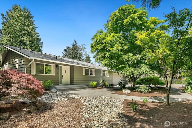 13235 68th Pl NE, Kirkland, WA 98034 - ranch-style home with an attached garage, driveway, and roof with shingles