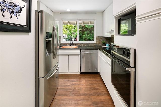 13235 68th Pl NE, Kirkland, WA 98034 - kitchen featuring appliances with stainless steel finishes, a sink, white cabinets, dark countertops, and dark wood finished floors
