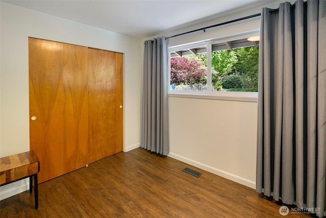 13235 68th Pl NE, Kirkland, WA 98034 - unfurnished bedroom with wood finished floors, a closet, and baseboards