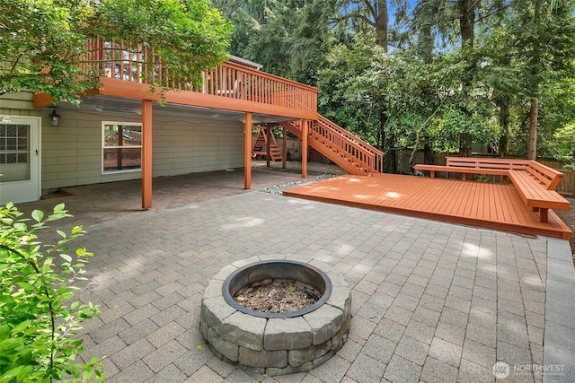 13235 68th Pl NE, Kirkland, WA 98034 - view of patio / terrace featuring an outdoor fire pit, a wooden deck, stairs, and fence