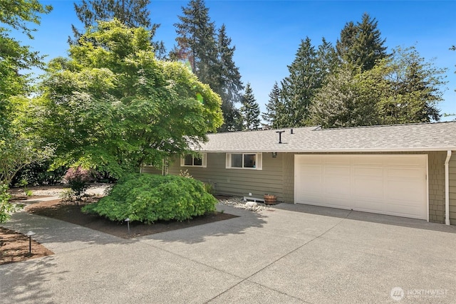 13235 68th Pl NE, Kirkland, WA 98034 - view of front of property featuring concrete driveway, a garage, and a shingled roof
