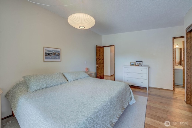 bedroom with light wood-style flooring and a sink