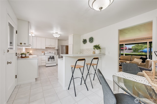 5915 148th Pl SW, Edmonds, WA 98026 - kitchen with electric stove, freestanding refrigerator, backsplash, under cabinet range hood, and light countertops