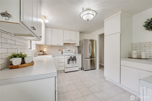 5915 148th Pl SW, Edmonds, WA 98026 - kitchen with white electric range, freestanding refrigerator, under cabinet range hood, a sink, and tasteful backsplash