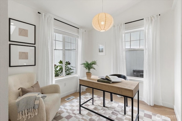 office featuring healthy amount of natural light, light wood-style flooring, and baseboards