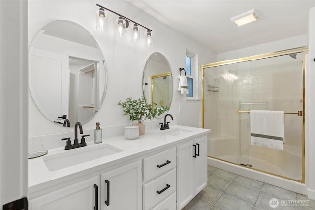 full bath with a shower stall, tile patterned floors, and double vanity