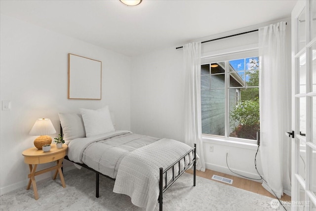 bedroom featuring baseboards and wood finished floors
