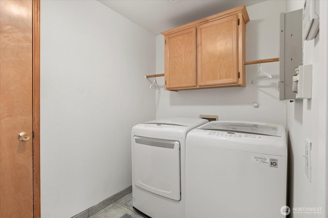 clothes washing area featuring cabinet space, separate washer and dryer, and baseboards