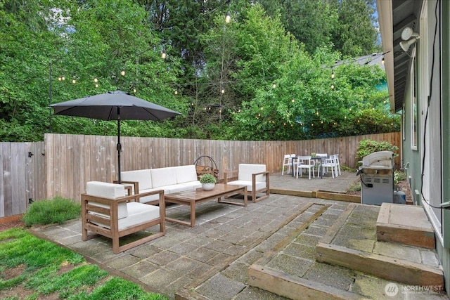 view of patio / terrace featuring a fenced backyard, an outdoor hangout area, and outdoor dining area