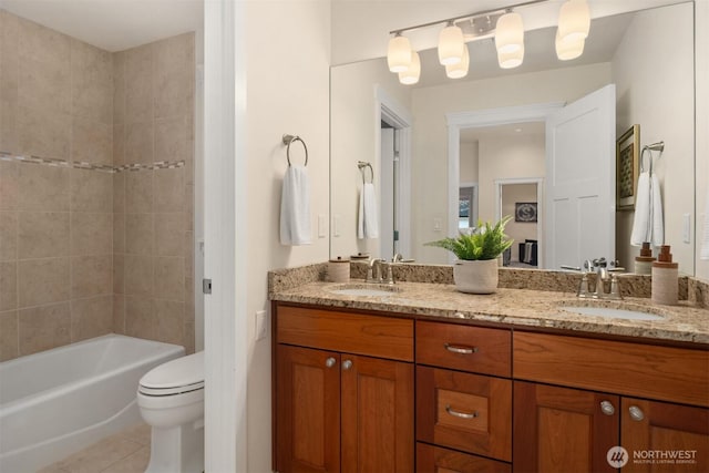 full bath with tile patterned flooring, toilet, double vanity, and washtub / shower combination