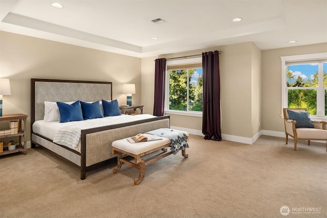 bedroom with a raised ceiling, light carpet, baseboards, and recessed lighting