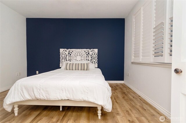 13000 Admiralty Way Unit K103, Everett, WA 98204 - bedroom featuring light wood-type flooring and baseboards