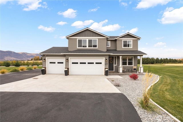 470 S Partridge Ln, East Wenatchee, WA 98802 - view of front of house with concrete driveway, covered porch, a front lawn, board and batten siding, and an attached garage