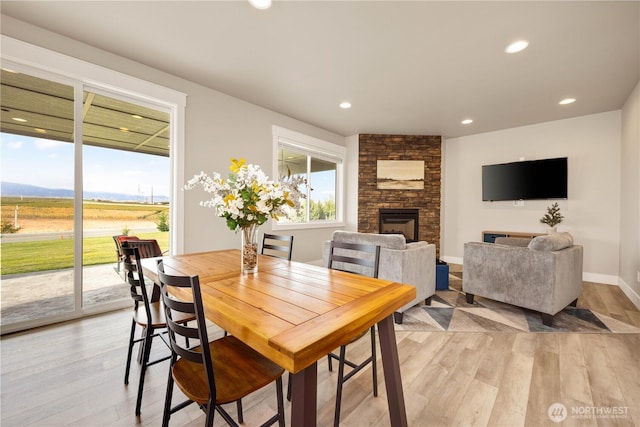 470 S Partridge Ln, East Wenatchee, WA 98802 - dining space with light wood-style floors, a fireplace, recessed lighting, baseboards, and a view of countryside