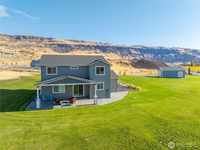 470 S Partridge Ln, East Wenatchee, WA 98802 - back of property featuring a mountain view, a shed, a patio area, and a lawn