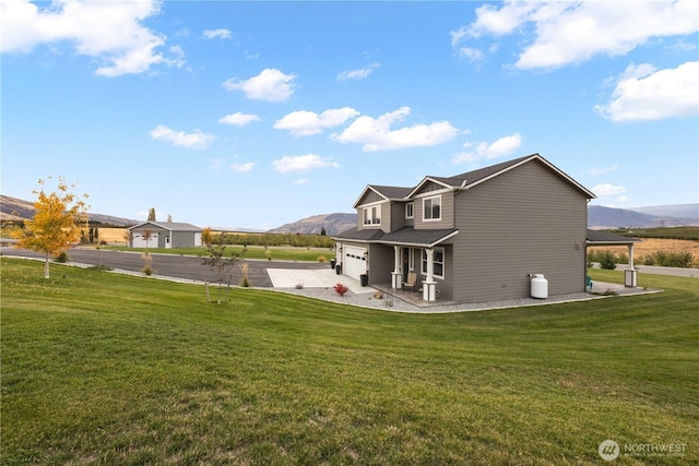 470 S Partridge Ln, East Wenatchee, WA 98802 - rear view of property with asphalt driveway, a mountain view, and a yard