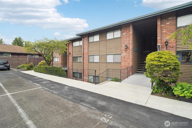 13558 37th Ave S Unit 21, Tukwila, WA 98168 - view of building exterior featuring stairs and fence