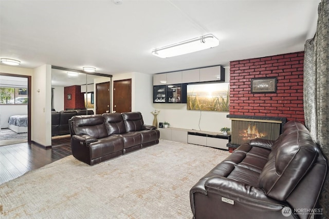 13558 37th Ave S Unit 21, Tukwila, WA 98168 - living room featuring a brick fireplace and wood finished floors