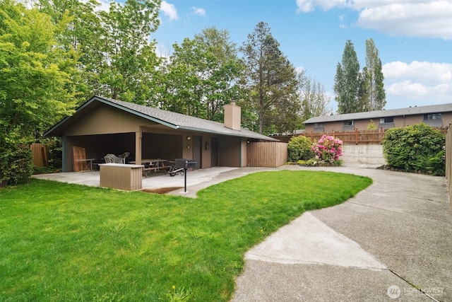 13558 37th Ave S Unit 21, Tukwila, WA 98168 - rear view of property with a chimney and a patio
