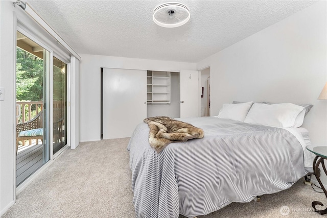 8309 Cirque Dr W Unit 4, University Place, WA 98467 - carpeted bedroom featuring access to exterior, a textured ceiling, and a closet