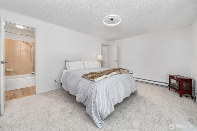8309 Cirque Dr W Unit 4, University Place, WA 98467 - carpeted bedroom featuring a baseboard heating unit, a textured ceiling, connected bathroom, and a wood stove