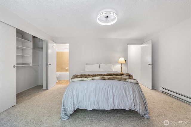 8309 Cirque Dr W Unit 4, University Place, WA 98467 - bedroom featuring light carpet, a baseboard radiator, ensuite bathroom, a textured ceiling, and a closet