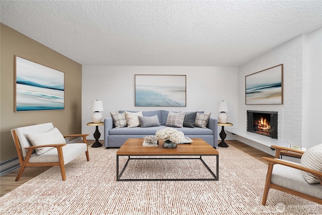 8309 Cirque Dr W Unit 4, University Place, WA 98467 - living room with wood finished floors, a fireplace, a textured ceiling, and baseboards