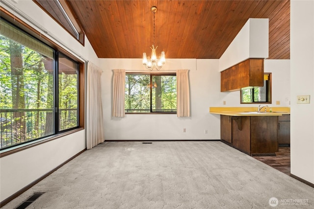 2431 W Lynnwood Dr, Longview, WA 98632 - kitchen with carpet, wooden ceiling, a chandelier, lofted ceiling, and baseboards