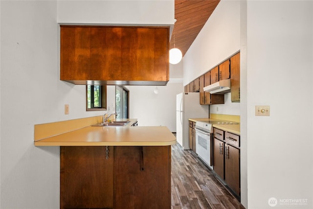2431 W Lynnwood Dr, Longview, WA 98632 - kitchen featuring under cabinet range hood, white appliances, a sink, a peninsula, and light countertops