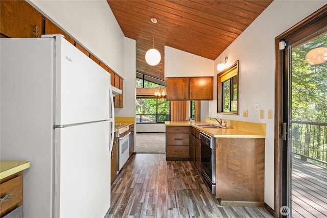 2431 W Lynnwood Dr, Longview, WA 98632 - kitchen featuring freestanding refrigerator, a sink, dark wood-type flooring, light countertops, and brown cabinetry