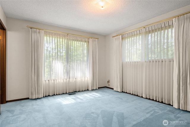 2431 W Lynnwood Dr, Longview, WA 98632 - carpeted empty room featuring a textured ceiling and baseboards