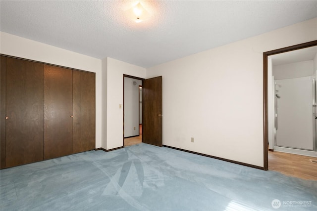 2431 W Lynnwood Dr, Longview, WA 98632 - unfurnished bedroom with carpet flooring, a closet, baseboards, and a textured ceiling
