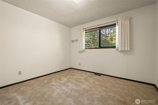 2431 W Lynnwood Dr, Longview, WA 98632 - carpeted spare room featuring baseboards and a textured ceiling