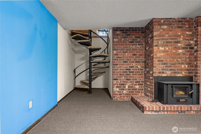 2431 W Lynnwood Dr, Longview, WA 98632 - unfurnished living room featuring a textured ceiling, carpet flooring, a fireplace, and baseboards