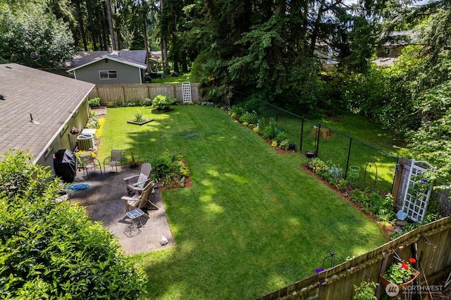 view of yard featuring a patio area and central AC