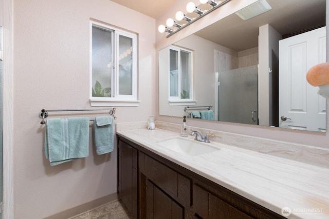 bathroom featuring a shower stall and vanity