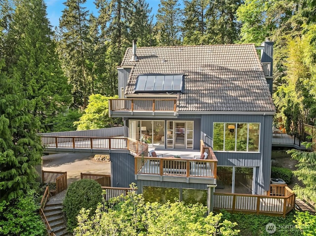 5047 84th Ave SE, Mercer Island, WA 98040 - back of property featuring a deck, a tiled roof, and a balcony