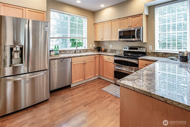 2050 132nd Ave SE Unit E-512, Bellevue, WA 98005 - kitchen with stainless steel appliances, light brown cabinetry, light wood finished floors, light stone countertops, and recessed lighting